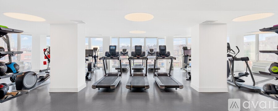 A gym with treadmills and elliptical machines.