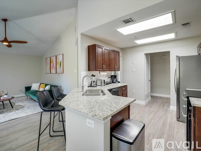 A kitchen with a white countertop and a refrigerator.
