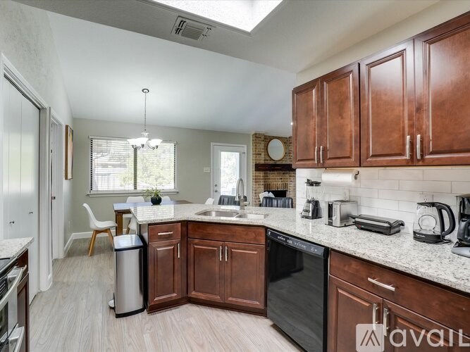 A kitchen with brown cabinets and a white countertop.
