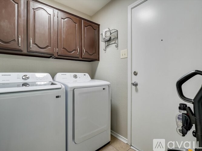 A small laundry room with a washer and dryer.