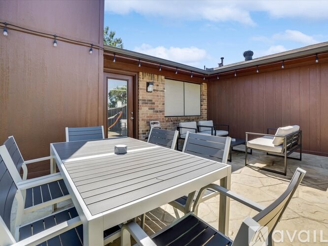 A patio with a table and chairs is available for rent.