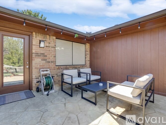 A patio with a table and chairs is available for rent.