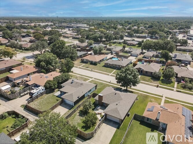 A bird's eye view of a residential neighborhood with houses and trees.