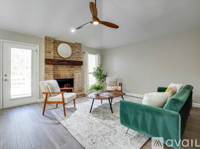 A living room with a green chair and a wooden table.