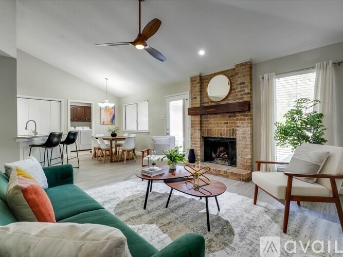 A living room with a fireplace and a ceiling fan.