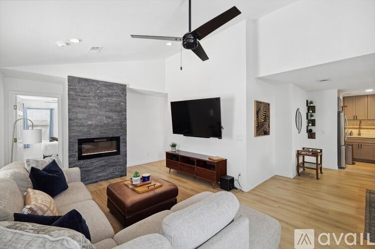 A living room with a grey couch and a brown coffee table.
