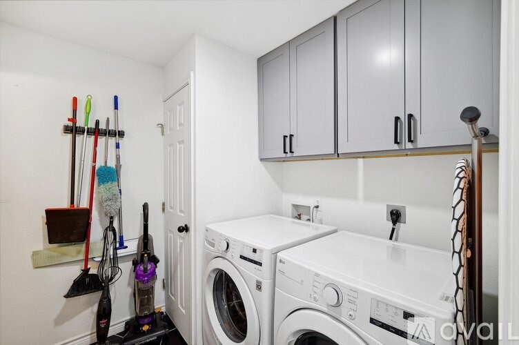 A white washing machine and dryer in a small laundry room.
