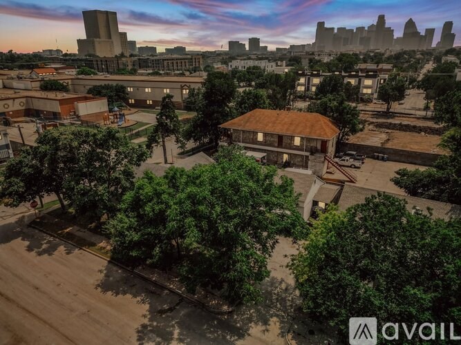 A building with a red roof is surrounded by trees.