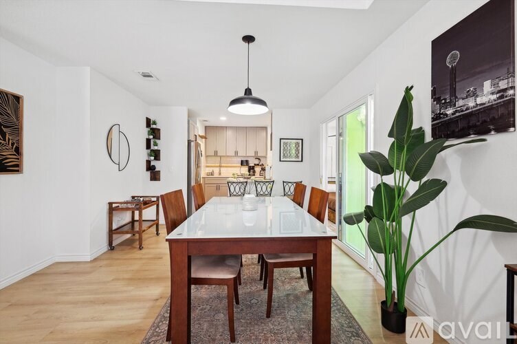 A dining room with a white table and chairs.