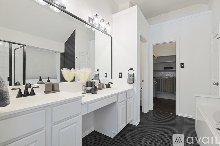 A bathroom with two sinks and a large mirror.