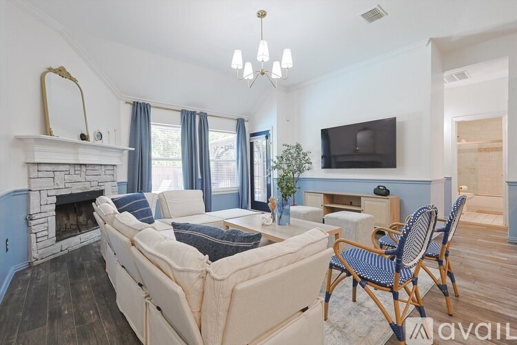 A living room with a fireplace, a couch, and a television.