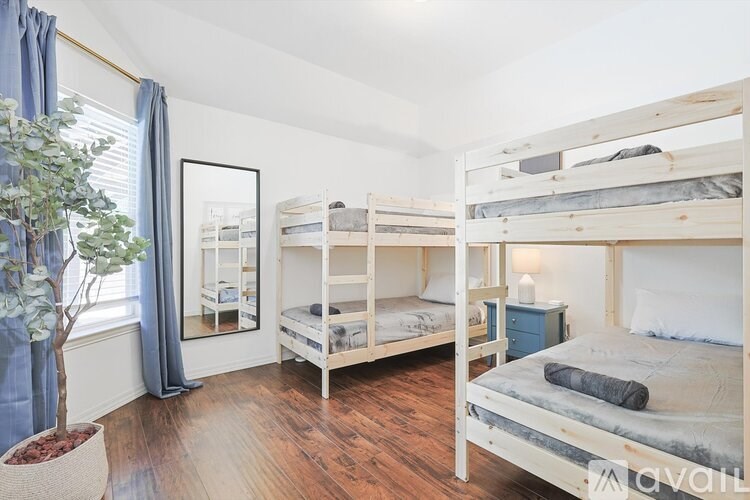 A bedroom with two bunk beds and a potted plant.