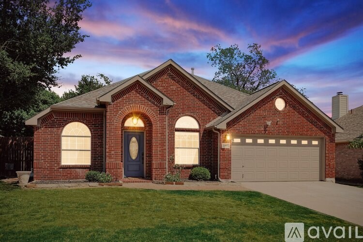 A house with a blue door and a garage is available for sale.