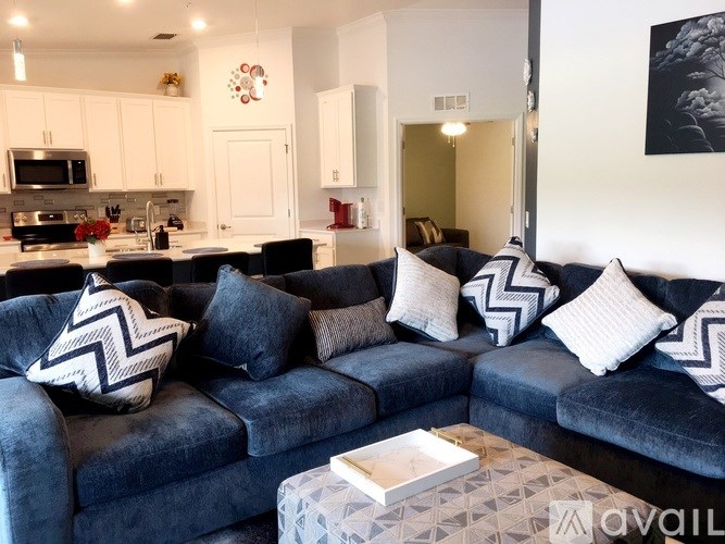 A living room with a blue couch and a coffee table.