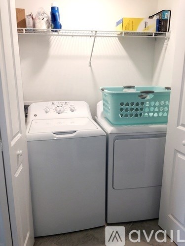 A small laundry room with a washer and dryer.