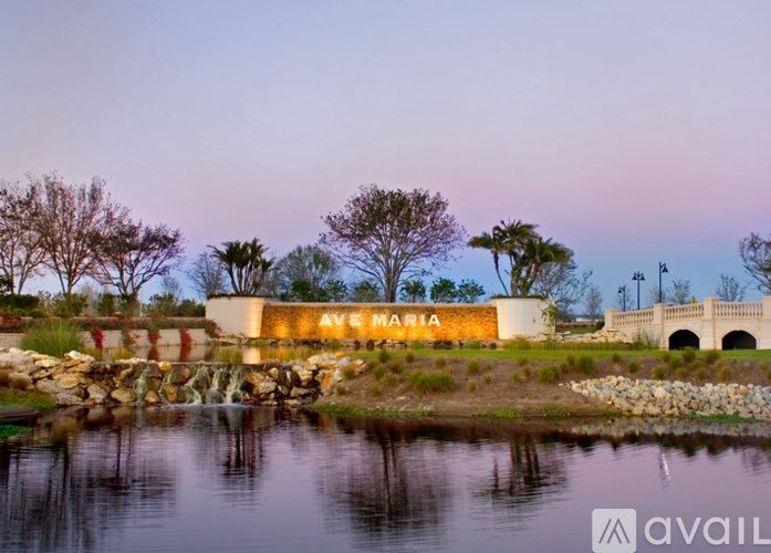 A building with the name "AVE MARIA" is reflected in a body of water.