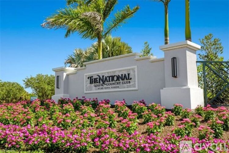 The National Golf Country Club sign is white and black.