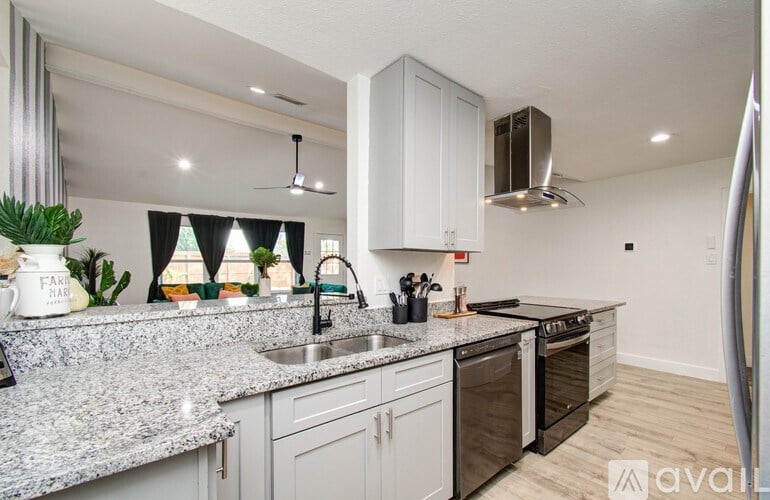 A kitchen with granite countertops and stainless steel appliances.