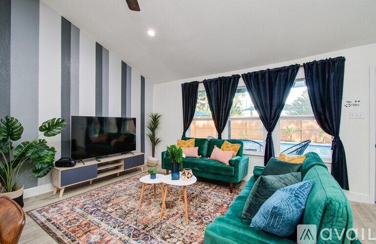 A living room with a green couch and a television.