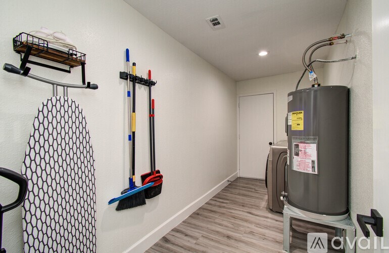 A room with a white wall and a black and white patterned curtain.