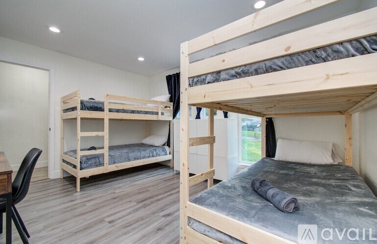 A bedroom with a bunk bed and a single bed.
