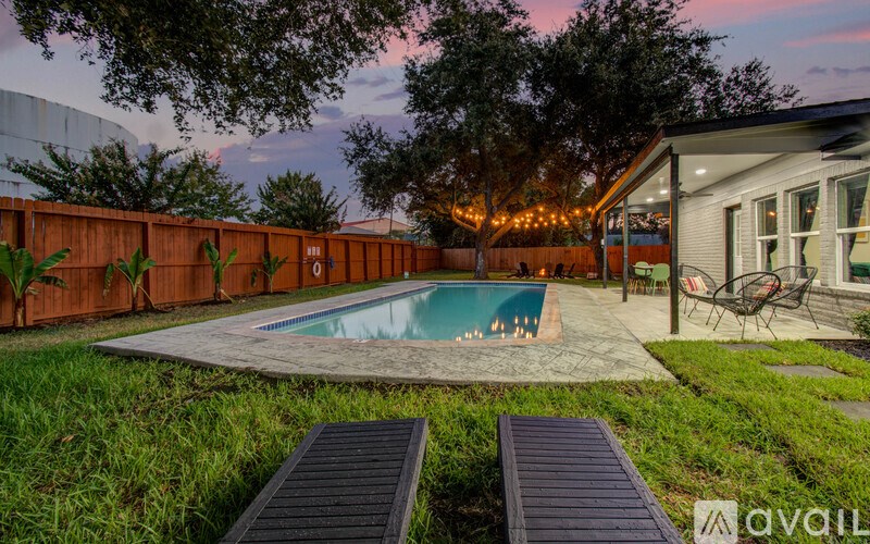 A backyard with a pool and deck.