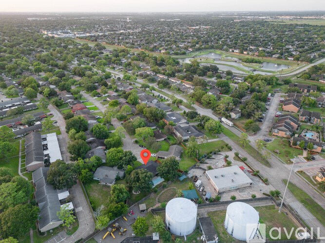 A bird's eye view of a residential area with a red marker indicating a specific location.
