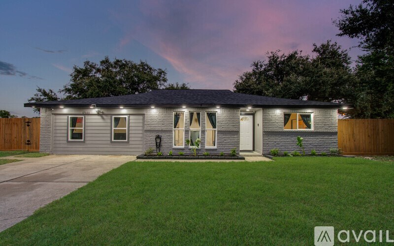 A house with a front yard and a driveway.