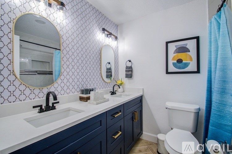 A bathroom with a white sink and a toilet.