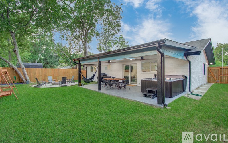 A backyard with a patio and a hot tub.