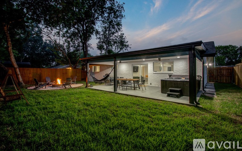 A backyard with a patio and a hammock.