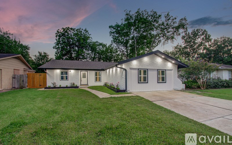 A house with a front yard and a driveway is available for purchase.
