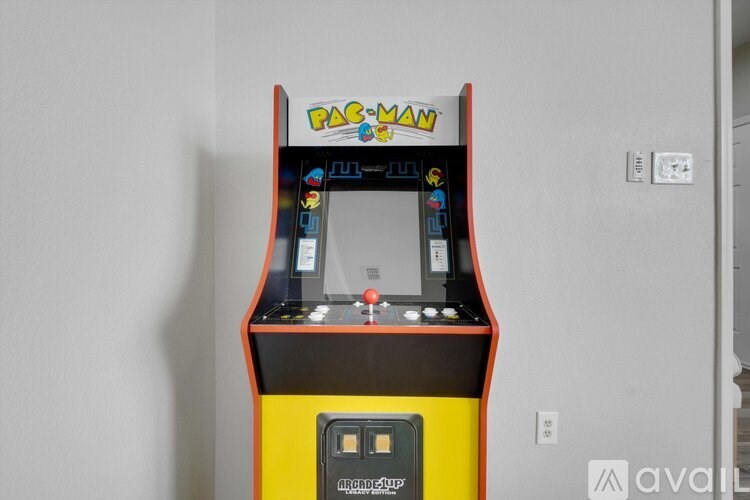 A Pac-Man arcade game machine with a yellow base and a red top.