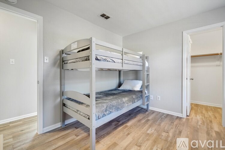 A room with a bunk bed and a single bed.