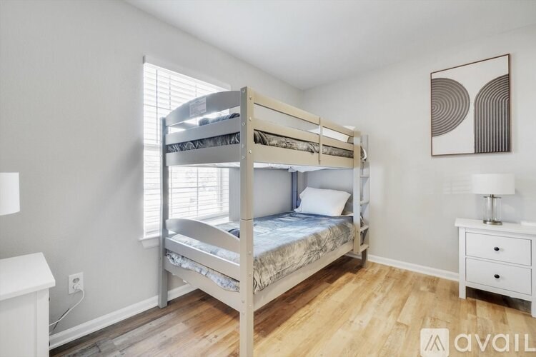A bedroom with a bunk bed and a nightstand.