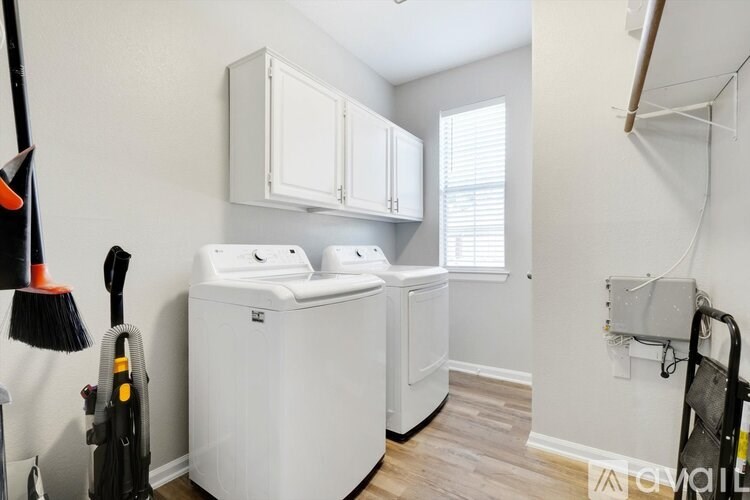 A small laundry room with a washer and dryer.