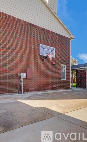 A basketball hoop mounted on a brick wall.