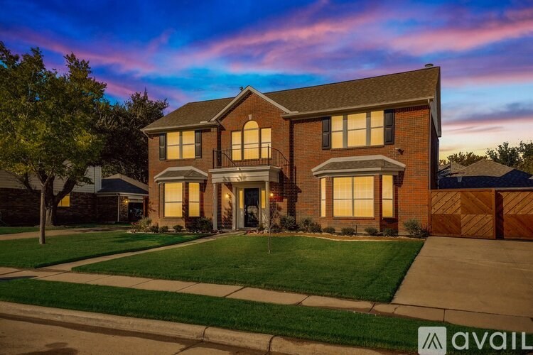 A house with a front yard and a driveway is available for sale.