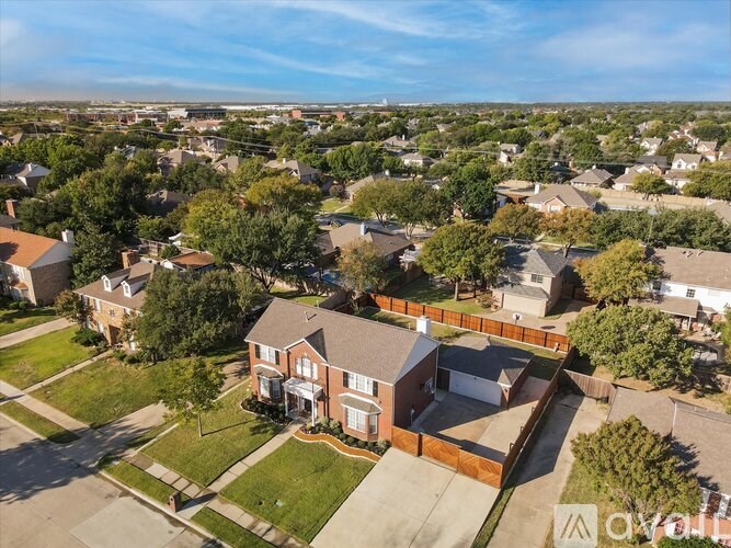 A bird's eye view of a residential area with houses and trees.