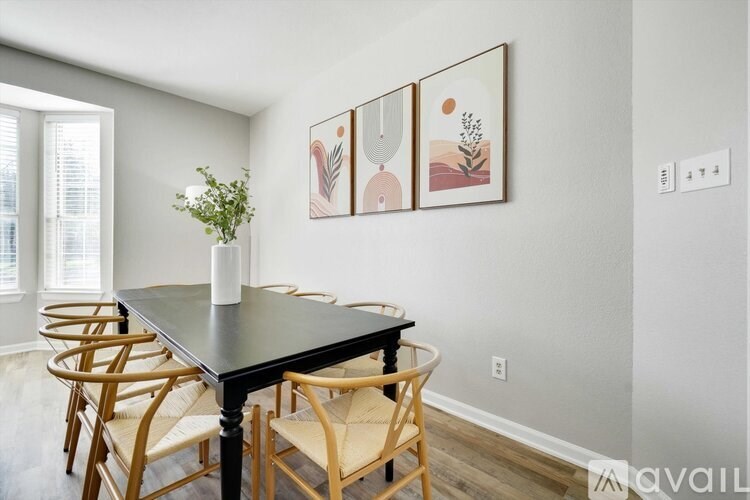 A dining room with a table and chairs.