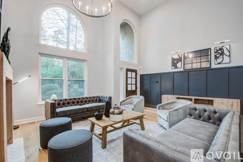 A living room with a grey couch and a wooden coffee table.