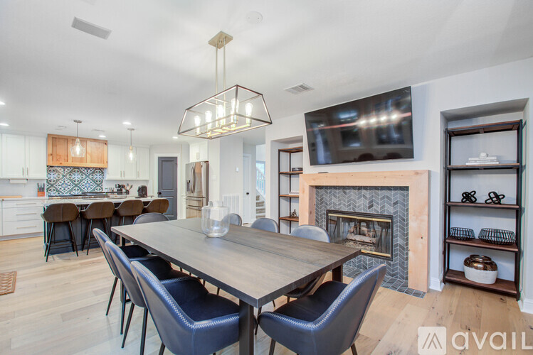 A modern dining room with a wooden table and chairs.