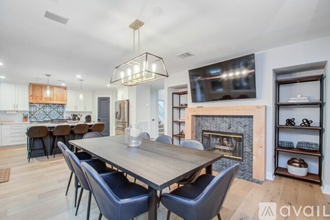 A modern dining room with a wooden table and chairs.
