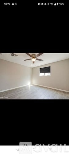 A room with a ceiling fan and a window.