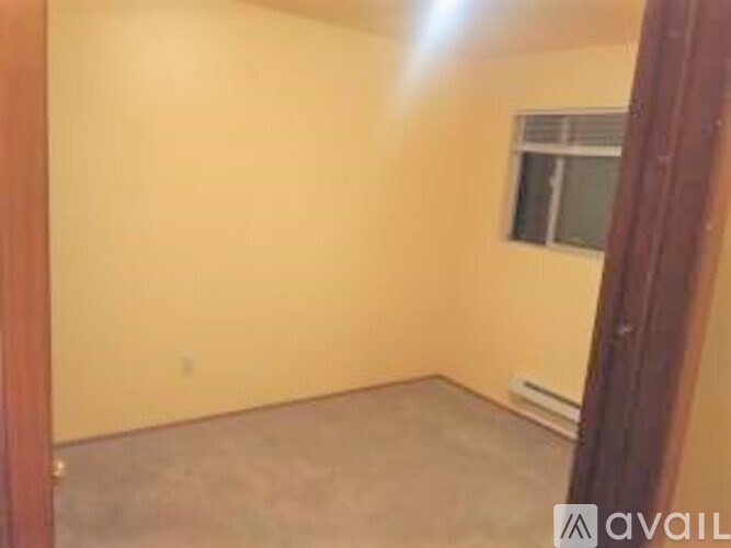 A room with a window and a door.