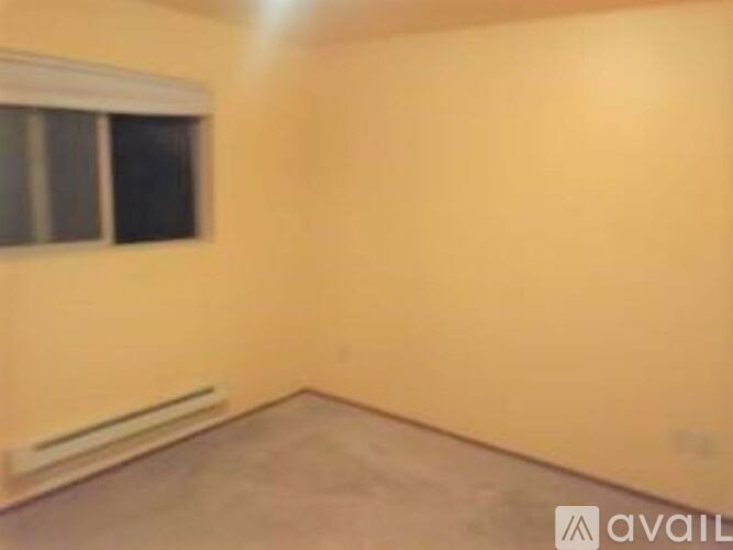 A room with a window and a radiator on the wall.