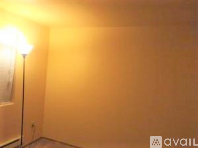 A lamp is on a stand in a room.