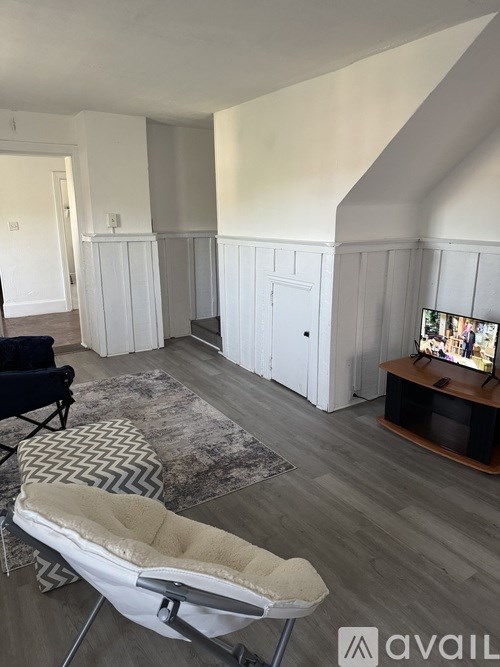 A living room with a chair and a television.
