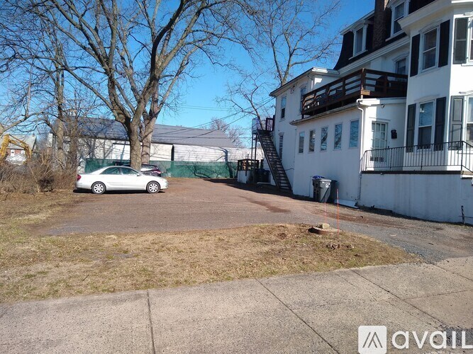 A car is parked in a driveway in front of a house.