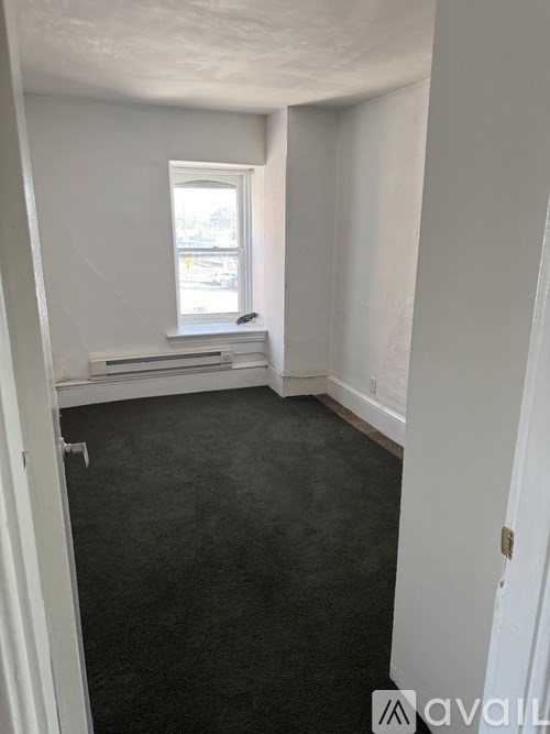 A room with a window and a door.